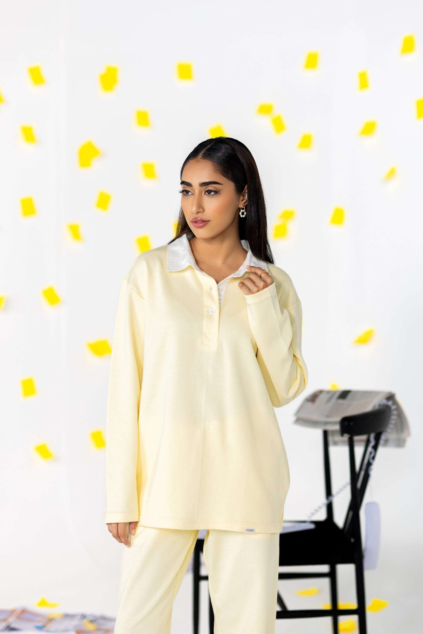 Model wearing the COZY Ladies Rugby Polo in soft yellow, showcasing its relaxed fit and modern style.