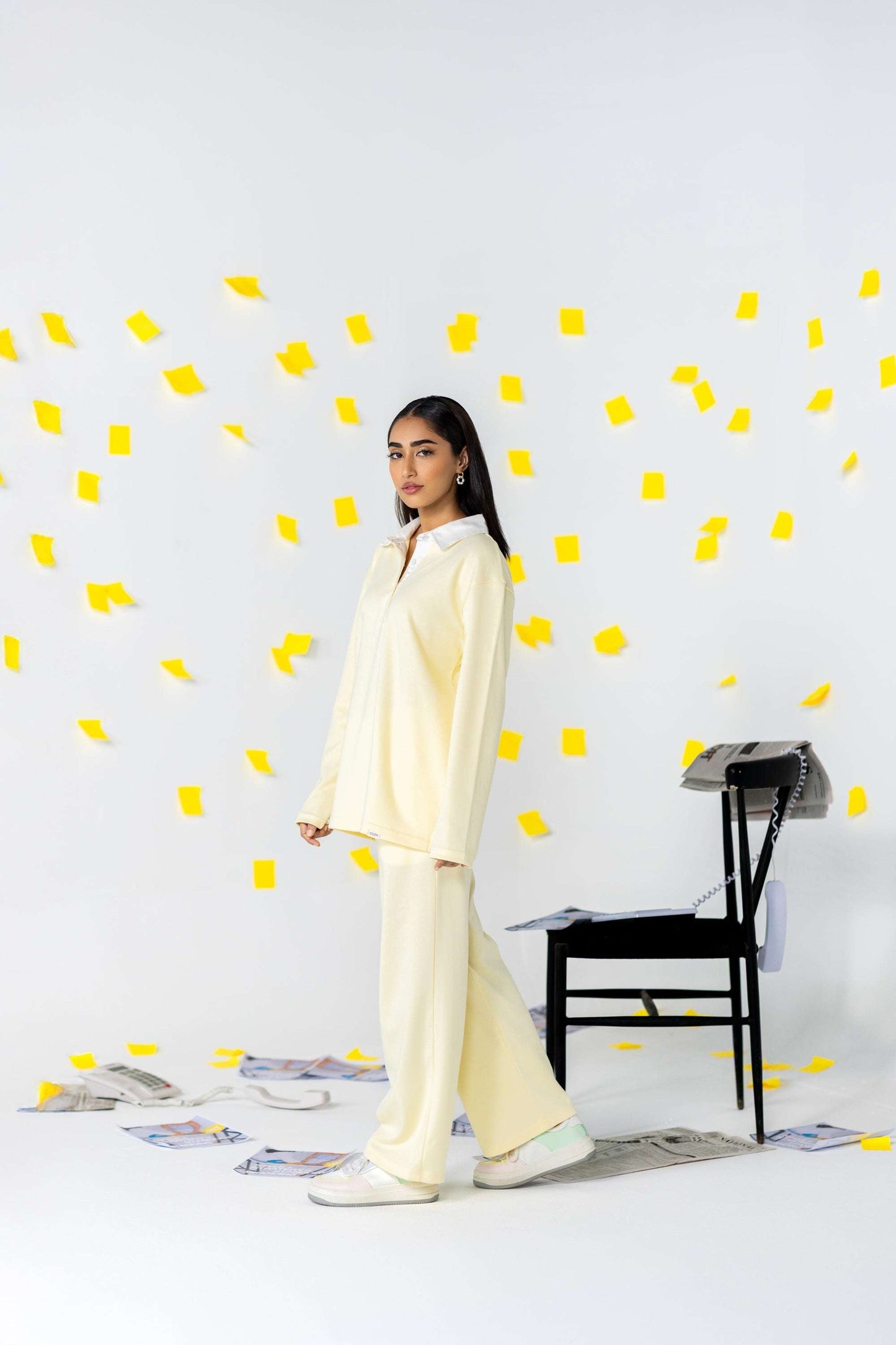 COZY Ladies Rugby Polo in soft yellow with relaxed fit, set against playful background of yellow sticky notes.