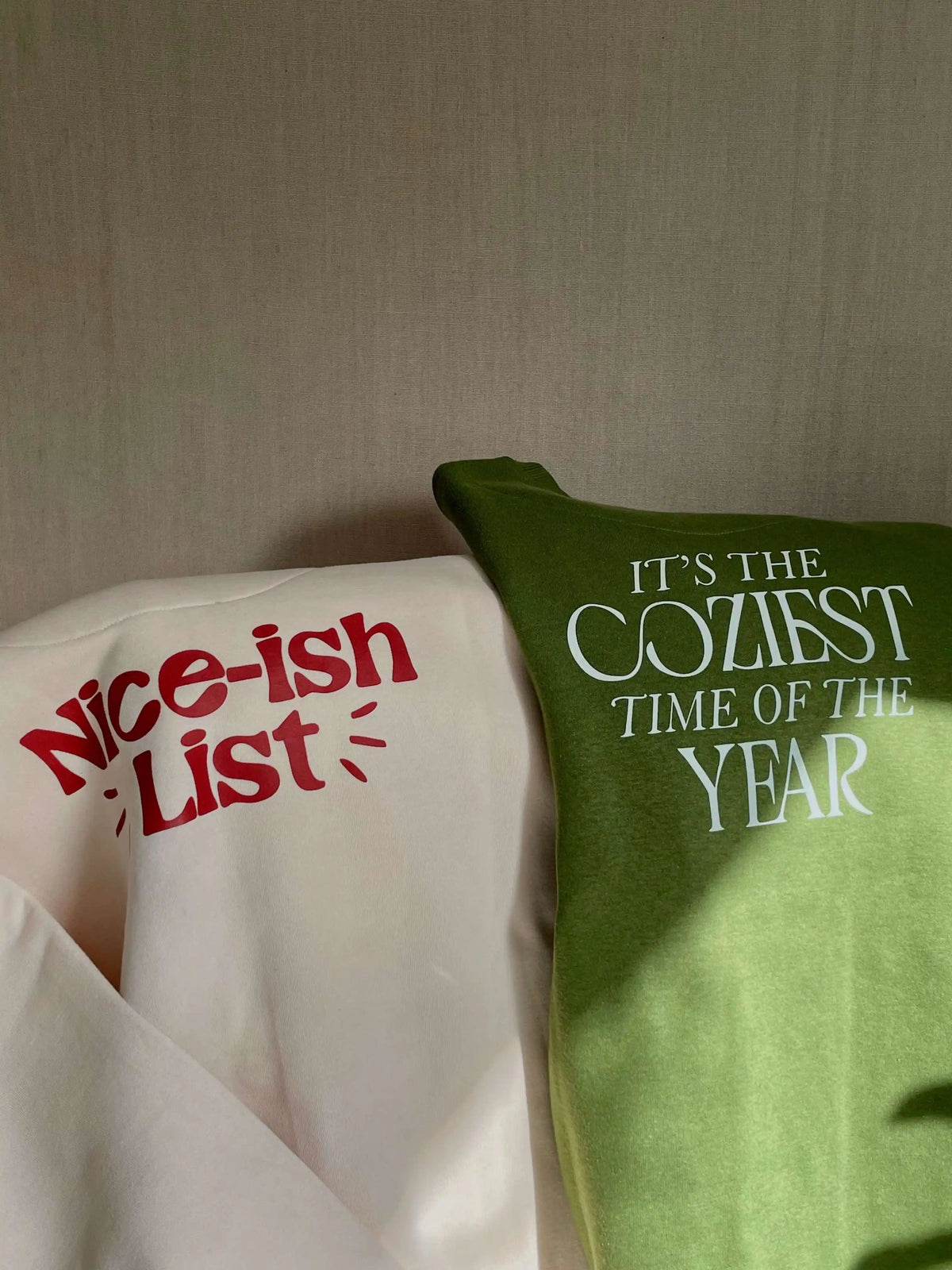 COZY Nice-ish List Sweatshirt: Two pillows with text 'Nice-ish List' and 'It's the Coziest Time of the Year' on a neutral background.