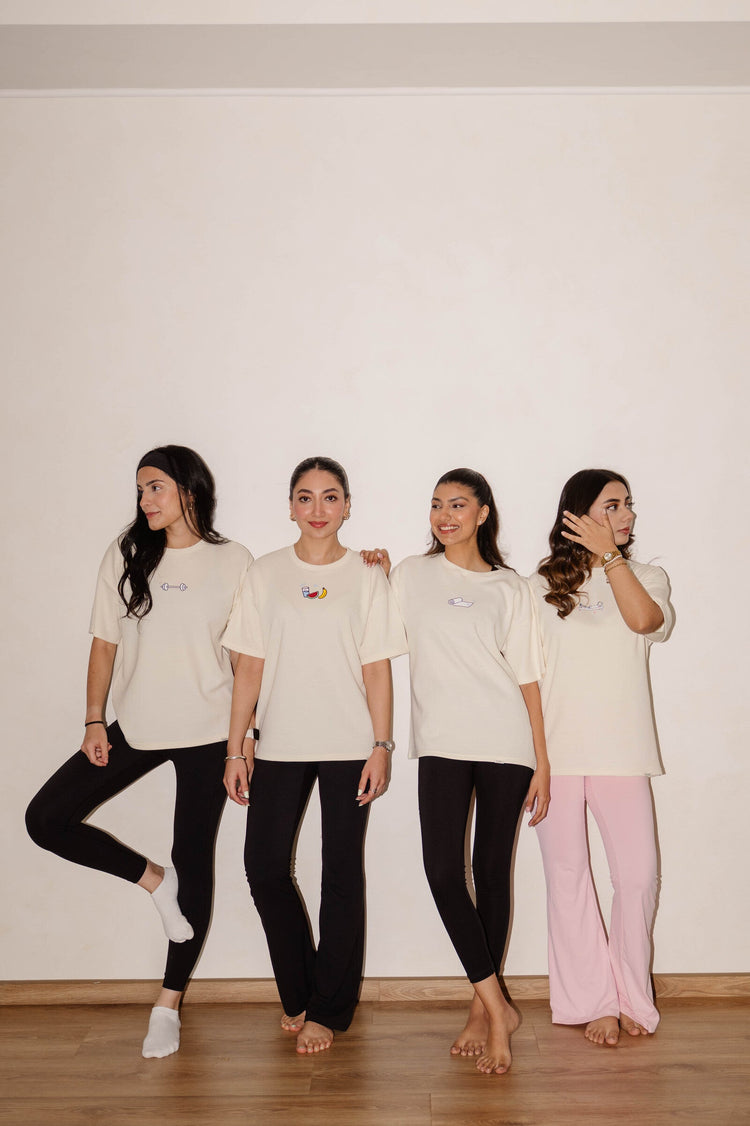 Limited edition clothing for women: four models in COZY Wellness Drop graphic tees