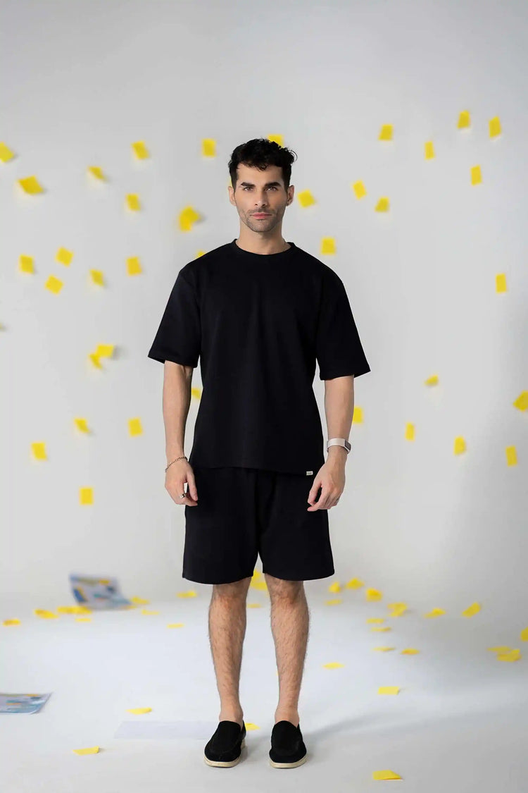 Shorts for men: model in black COZY Cotton shorts and a matching oversized tee