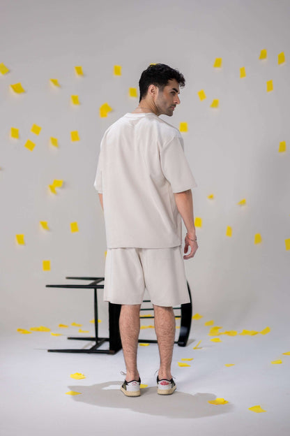 Model wearing COZY Shorts V2 in light gray, showcasing relaxed fit and comfortable style with organic cotton.