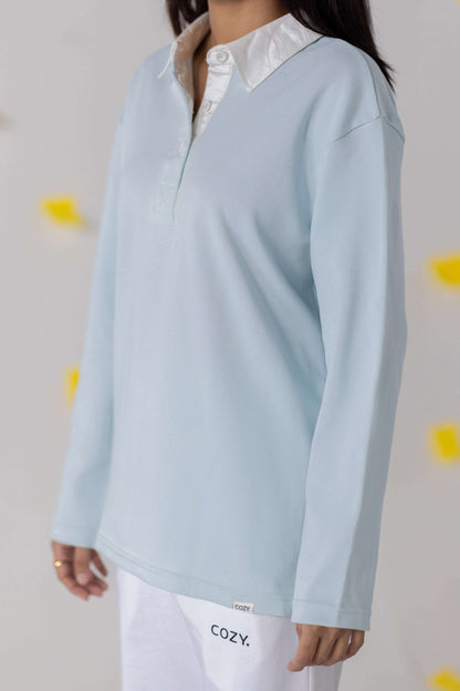COZY Ladies Rugby Polo in soft blue featuring a relaxed fit and classic rugby-inspired design.