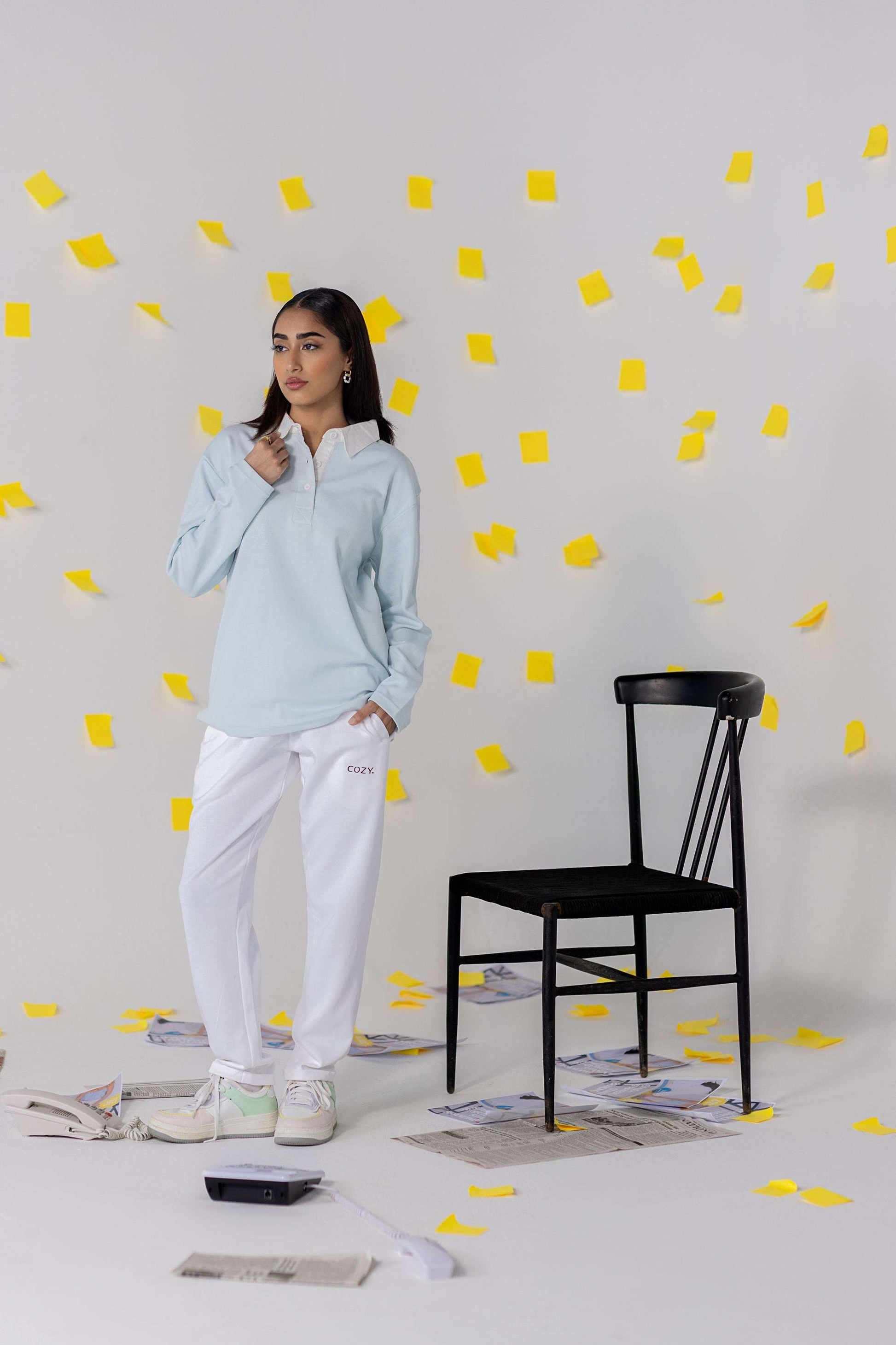 COZY Ladies Rugby Polo styled with relaxed fit pants in a dynamic setting with yellow sticky notes.