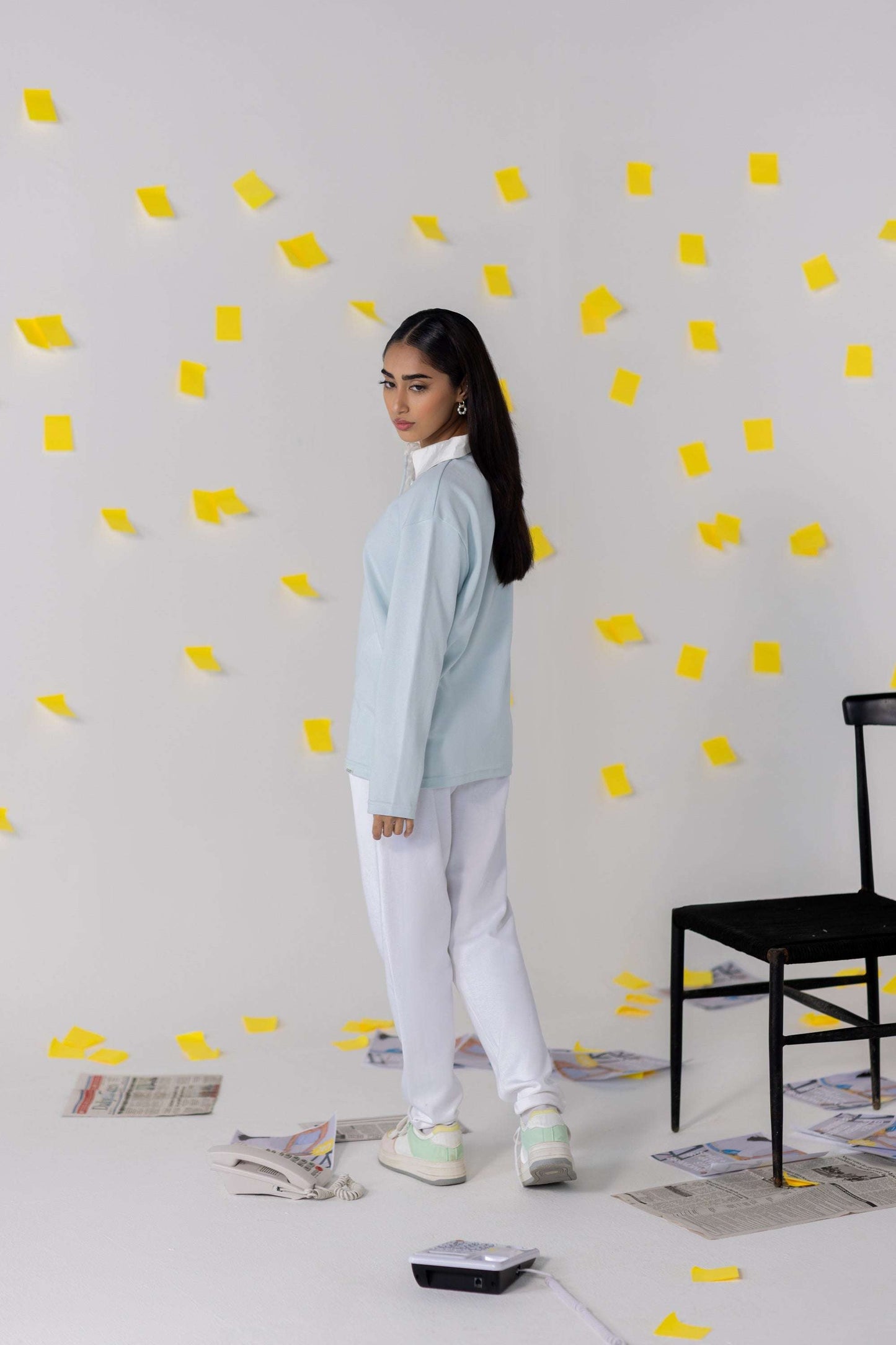 Model wearing COZY Ladies Rugby Polo in light blue, surrounded by yellow sticky notes, showcasing relaxed fit and modern style.