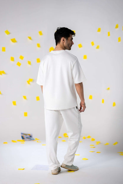 COZY Men's Classic Fit Pants worn by a man in a minimalist setting with yellow confetti.