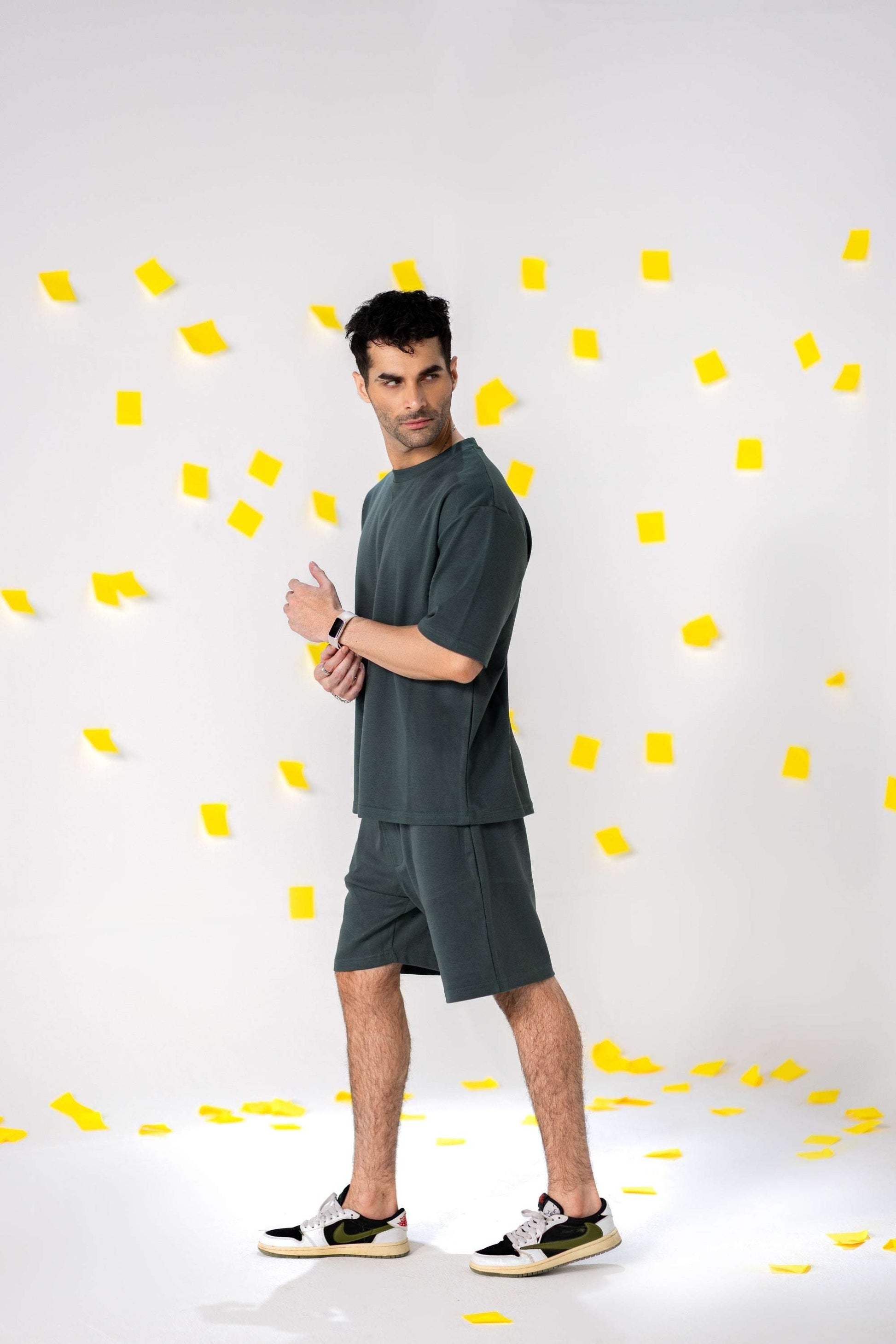 Model wearing COZY Shorts V2 in relaxed fit, showcasing organic cotton comfort and fall fit style against a colorful background.