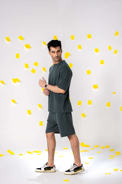 Model wearing COZY Shorts V2 in relaxed fit, showcasing organic cotton comfort and fall fit style against a colorful background.