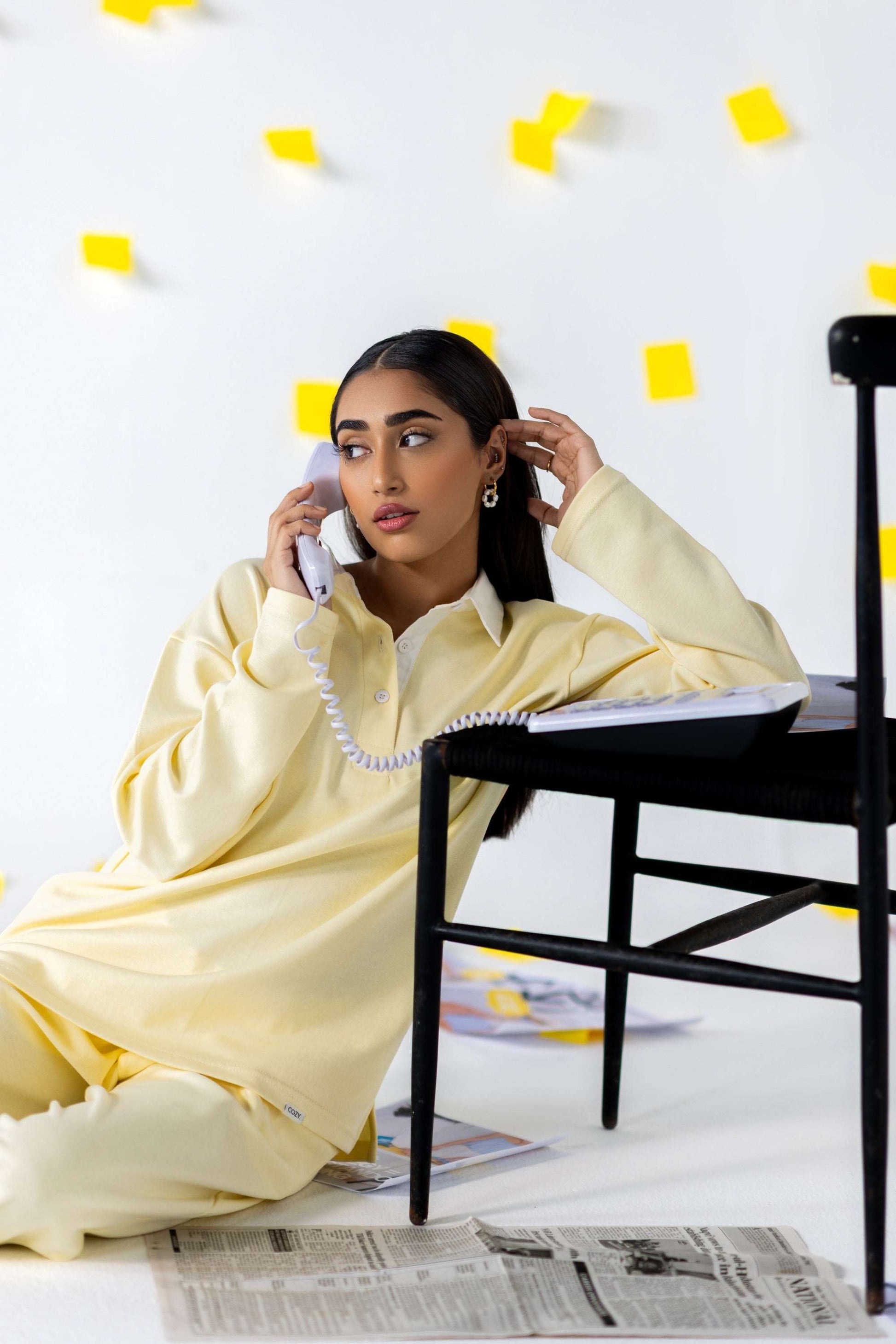 Model wearing COZY Ladies Rugby Polo in yellow, styled with relaxed fit in a modern, casual setting.