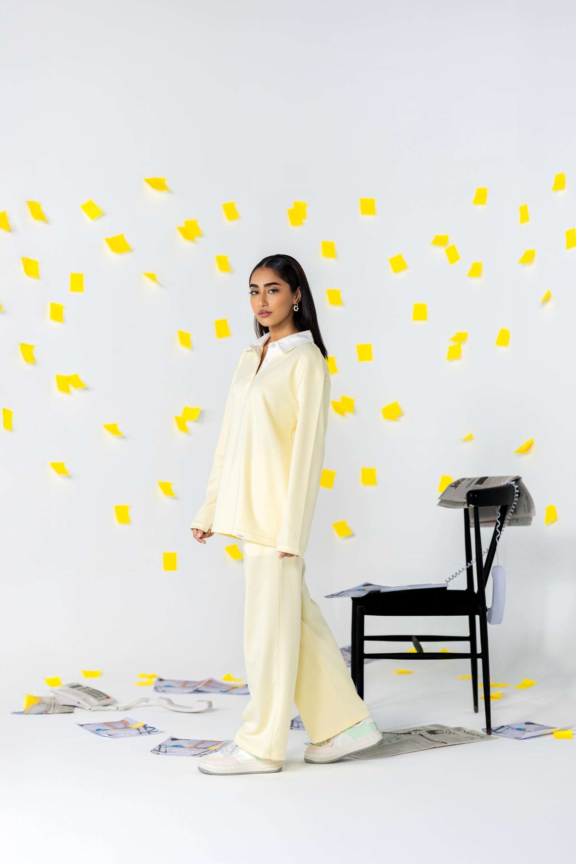 COZY Ladies Rugby Polo in soft yellow with relaxed fit, set against playful background of yellow sticky notes.