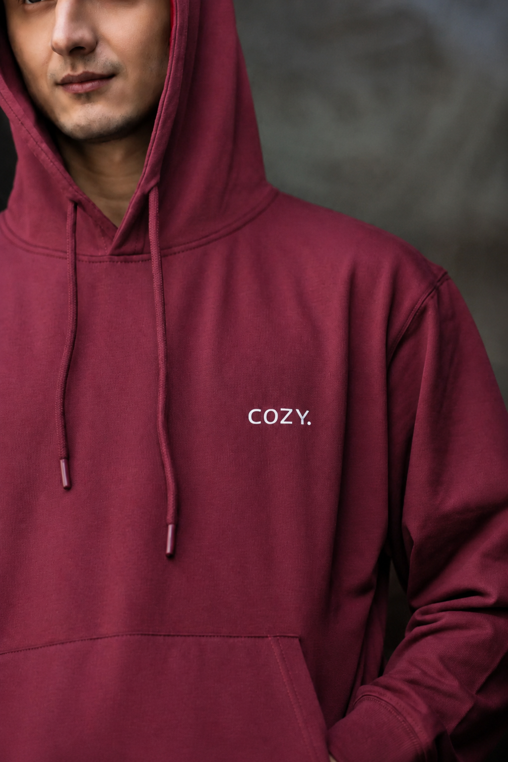 Close-up of the COZY Men's Hoodie in Mulberry Mocha showing the small COZY logo on the chest, drawstrings and hood