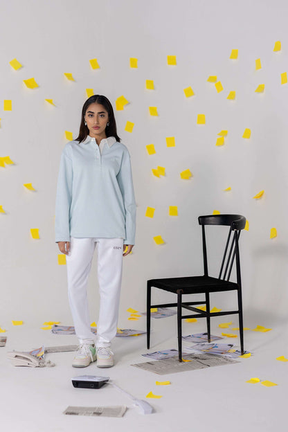 COZY Ladies Rugby Polo in light blue, featuring relaxed fit and organic cotton, styled with white bottoms.