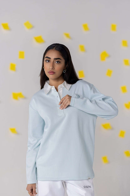 COZY Ladies Rugby Polo in light blue with relaxed fit, showcasing modern comfort and timeless style.