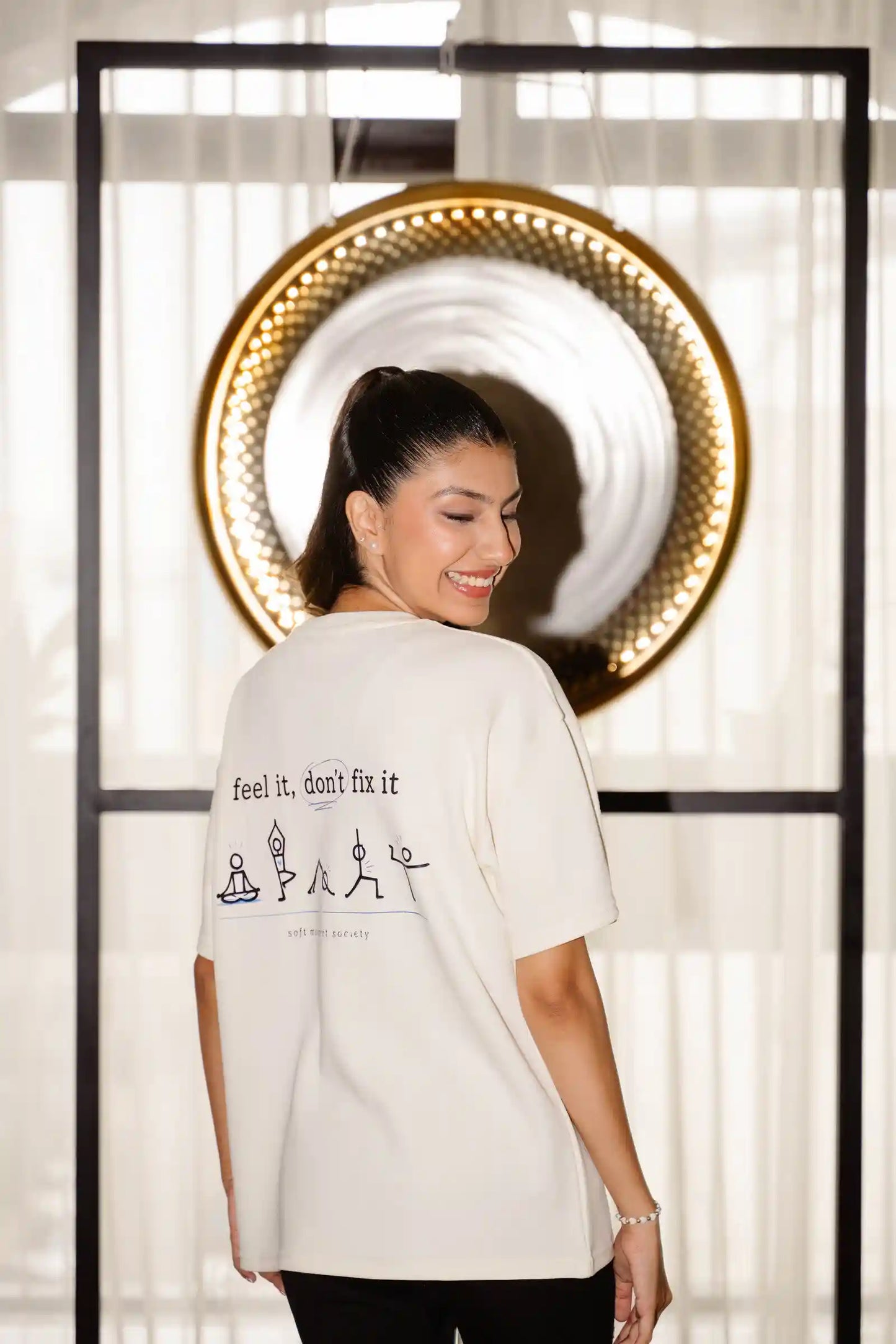Feel It Don't Fix It oversized tee in cream COZY Cotton, back print worn by model standing