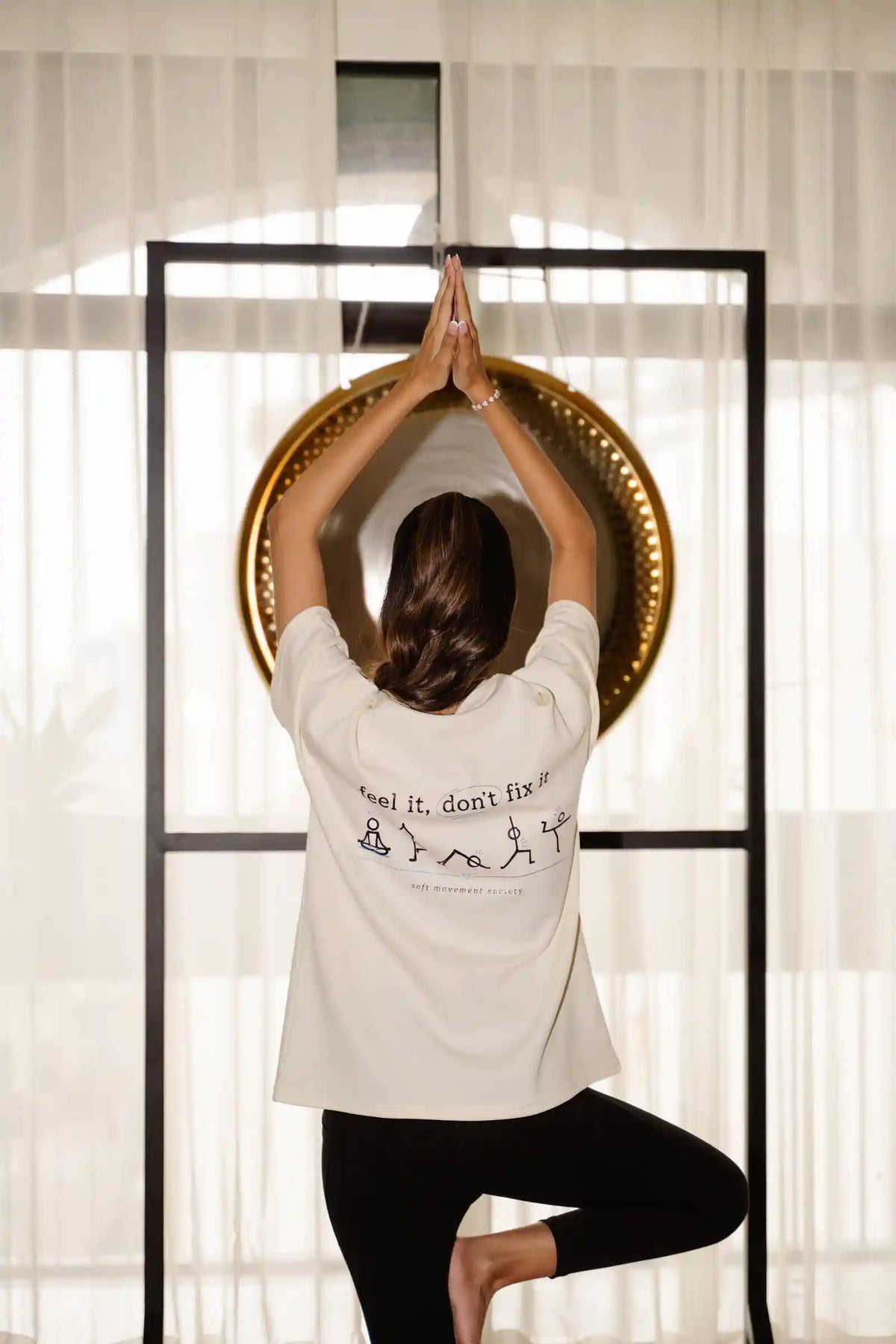 Feel It Don't Fix It oversized tee in cream COZY Cotton, back print model in tree pose