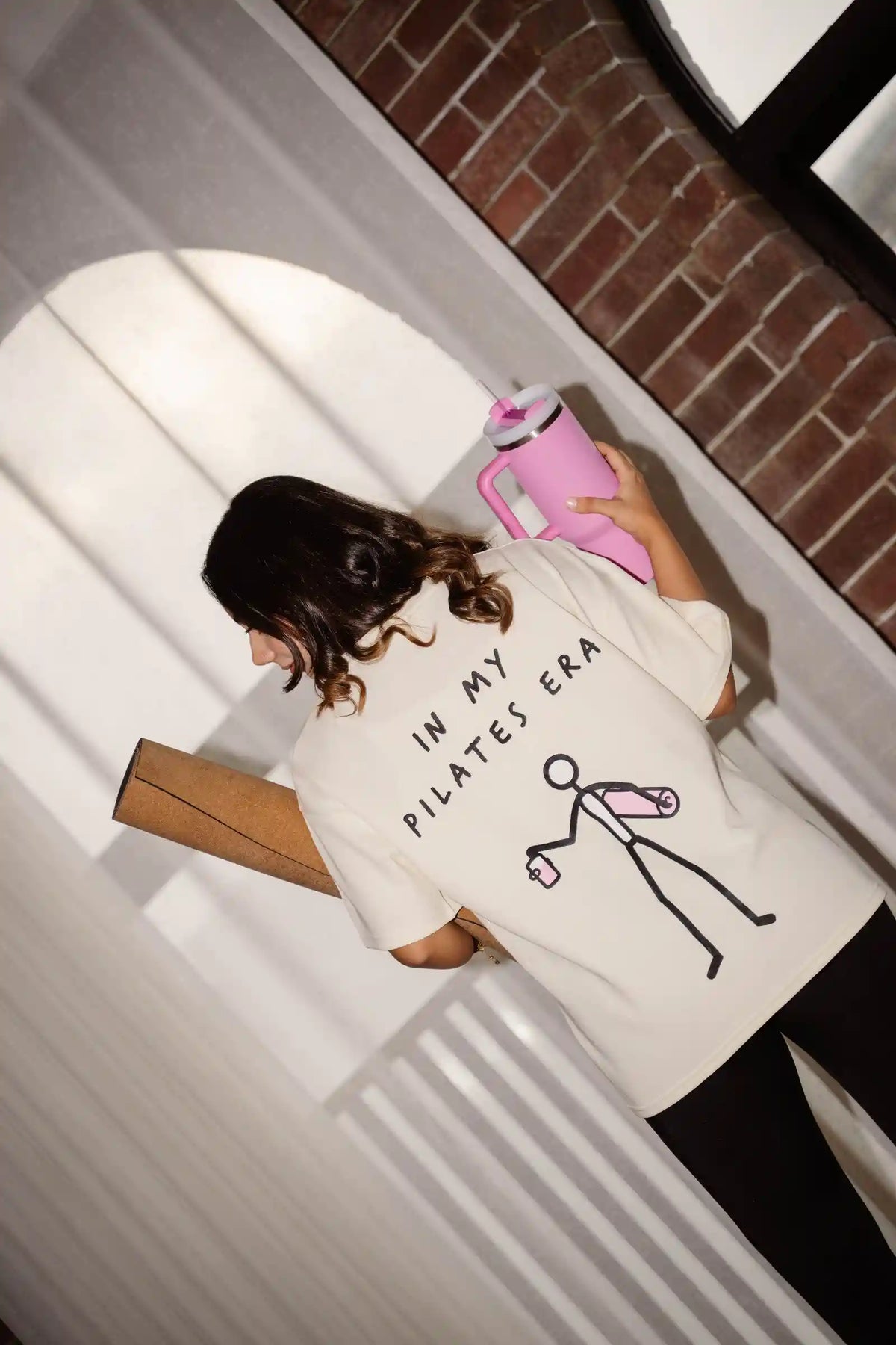 In My Pilates Era oversized tee in COZY Cotton, back print worn by model with pilates bag